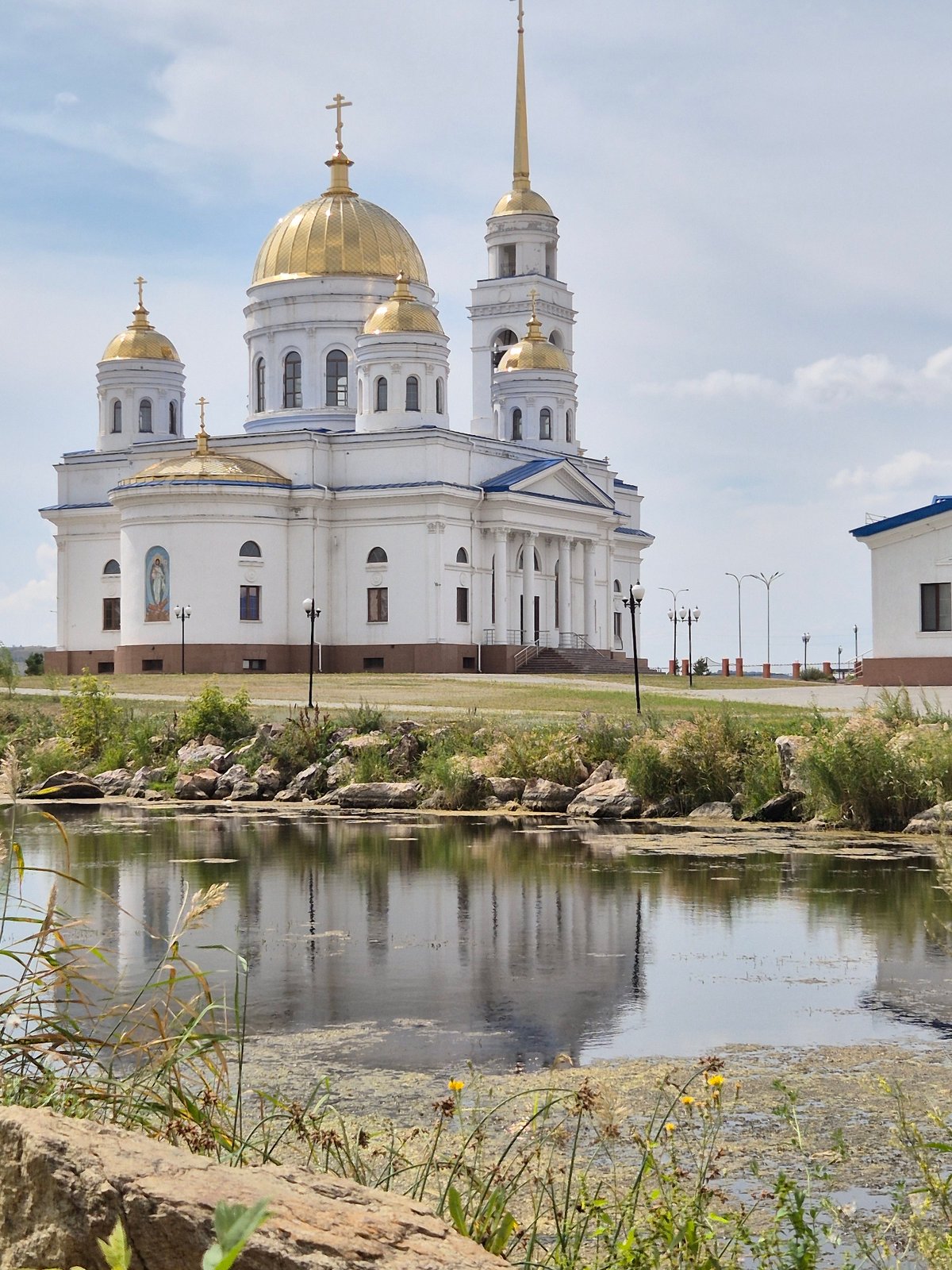 Lakeside park stroll past Kokshetau's cathedral, crane statue, and gazebo