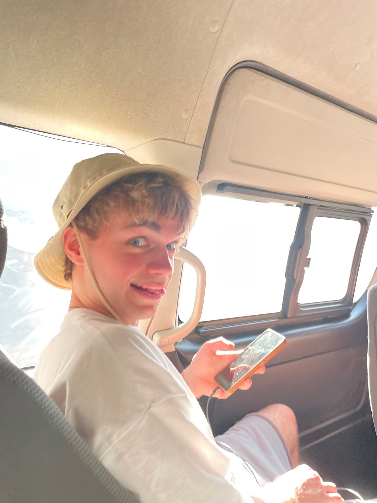Young person uses smartphone in vehicle in Melaya, Indonesia