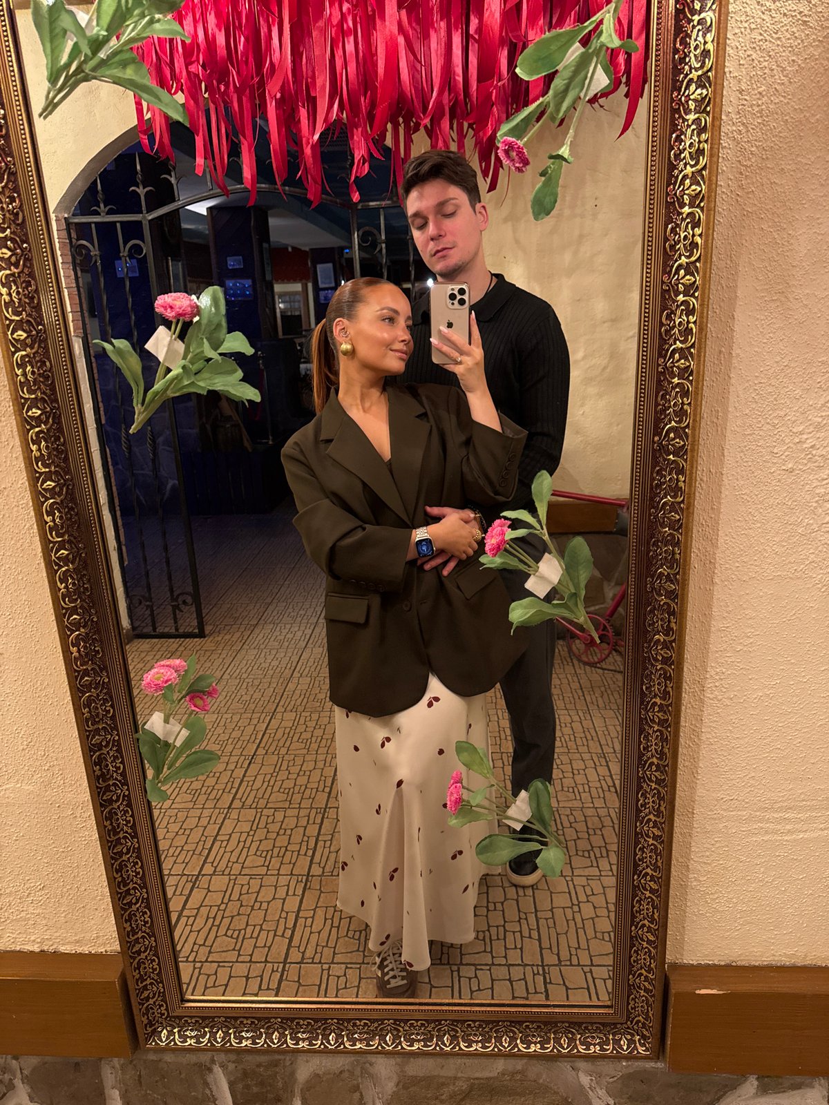 Couple takes selfie in ornate mirror in Chaikovsky