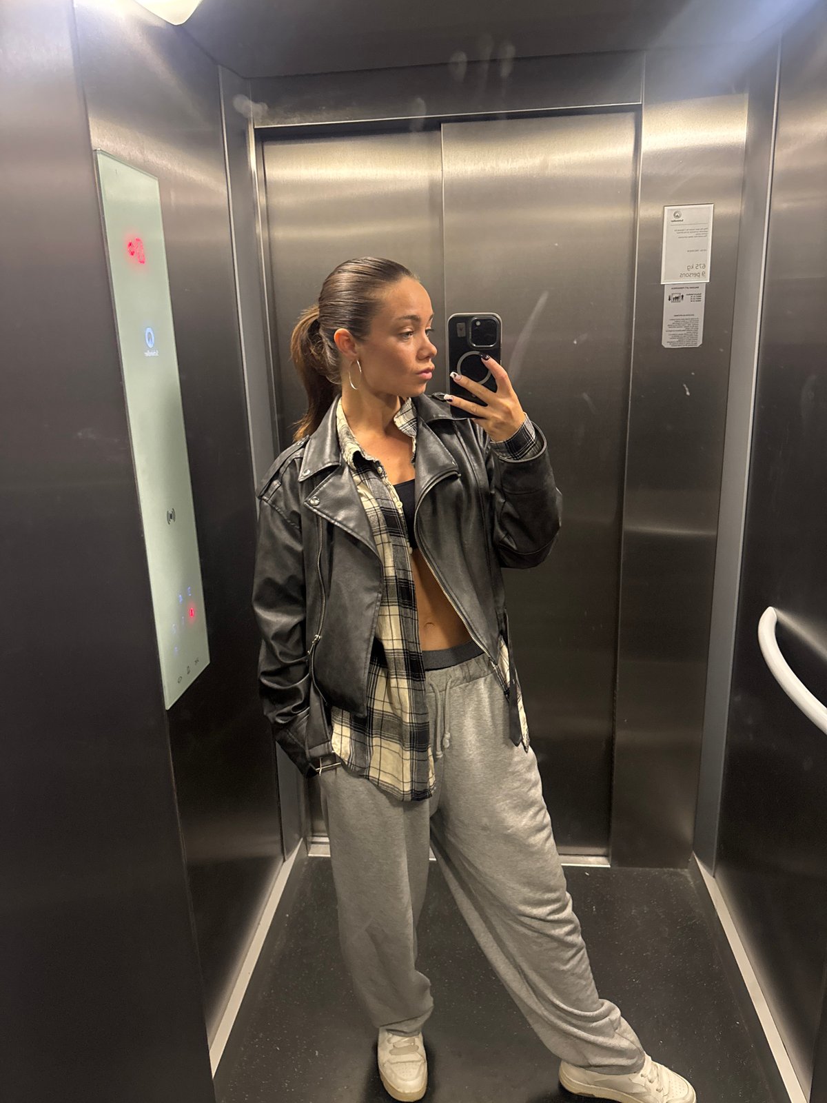 Woman documents rainy morning with elevator selfies in Budva