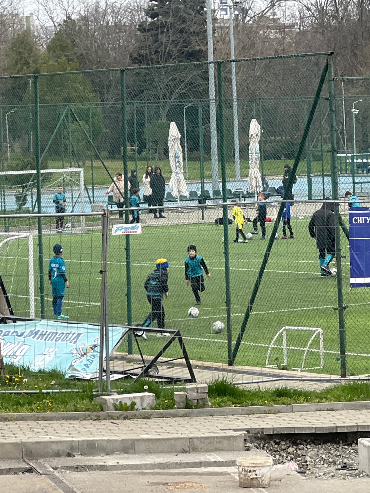 Youth soccer game and park pathway observed in Burgas