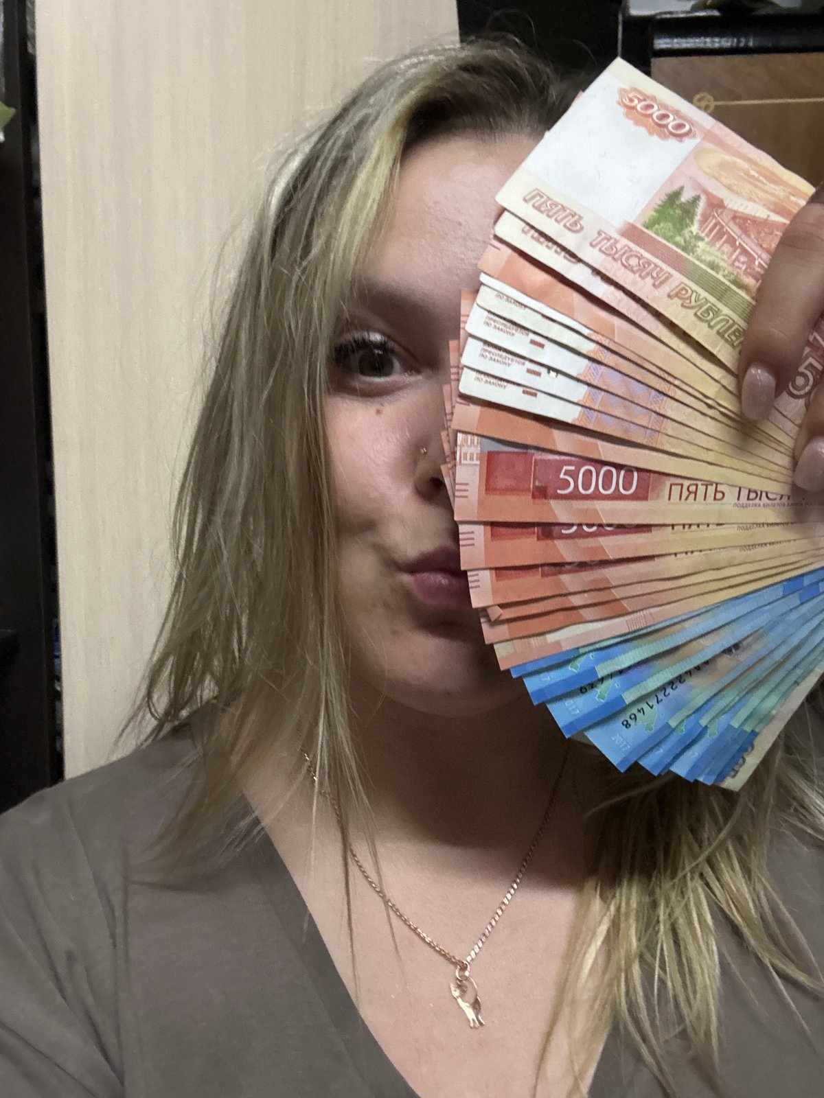 Woman poses with Russian rubles in Марковский