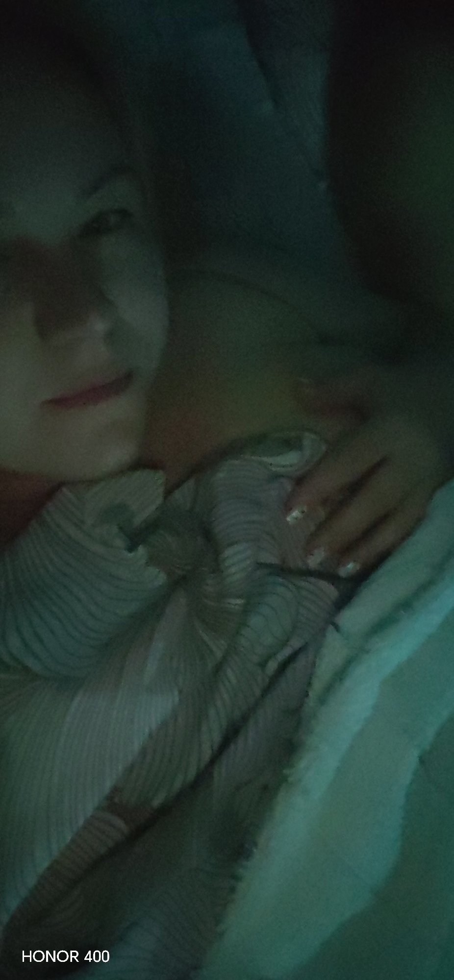 Person resting indoors in bedroom in Noviy, Russia