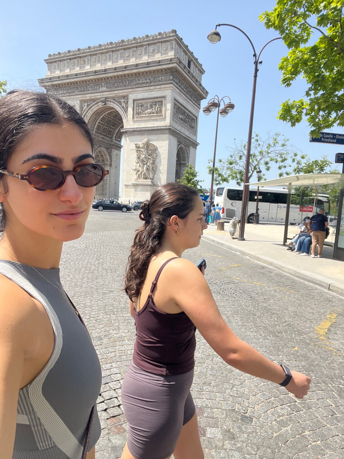 Tourists pose for photos at Arc de Triomphe
