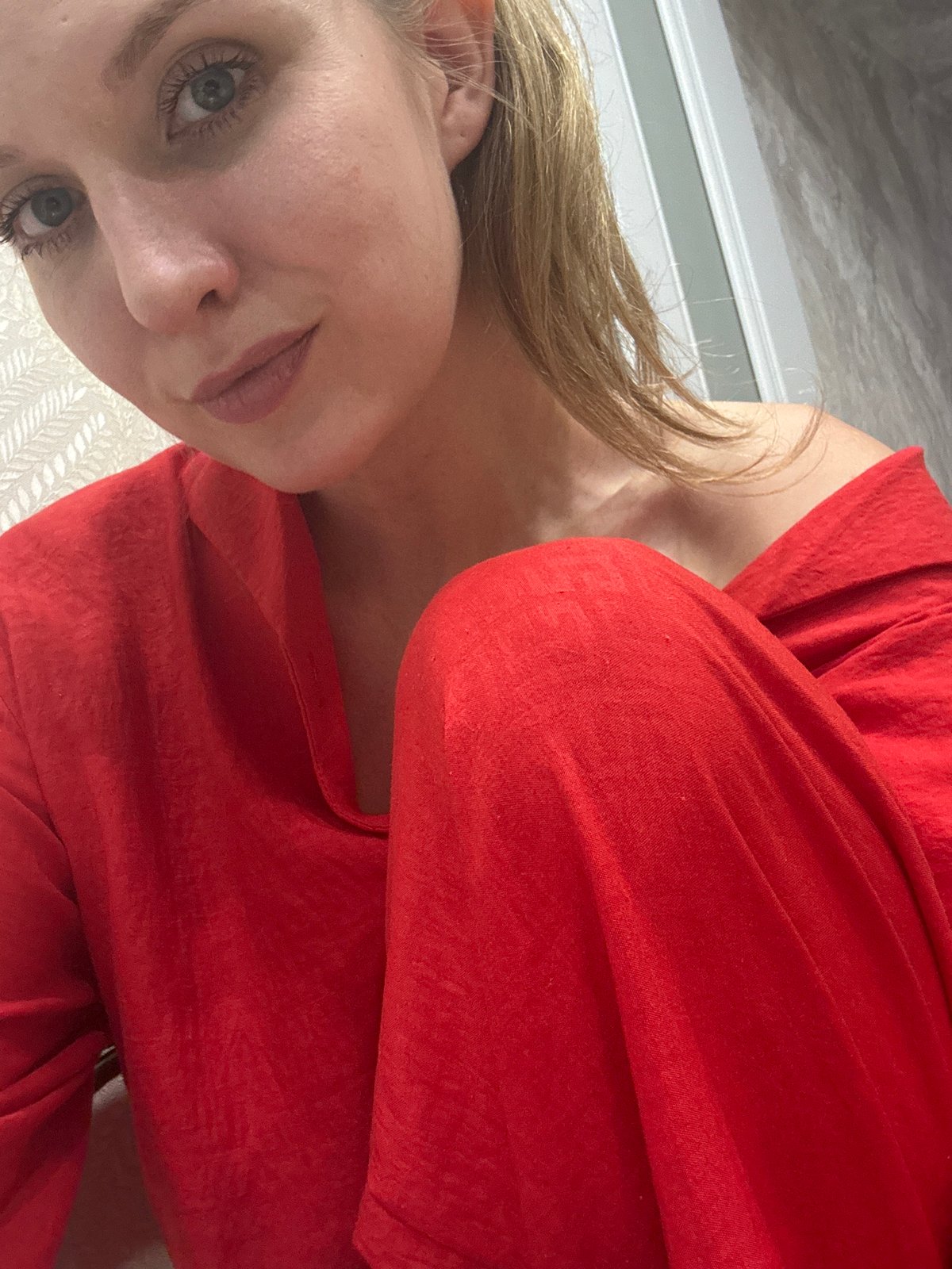 Woman in red pajamas conducts kitchen activities in Izhevsk home