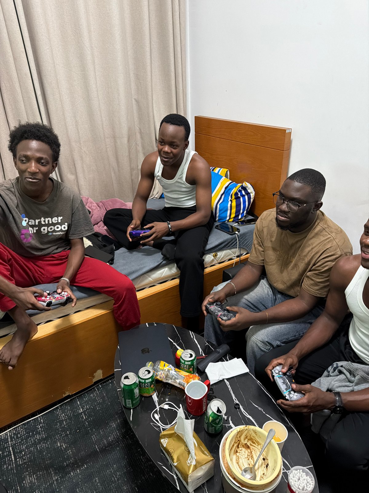 Four men gaming indoors in Jiangning District, China