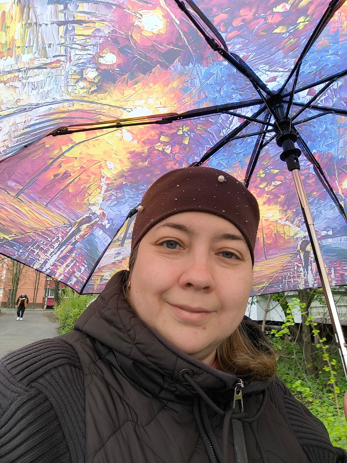 Woman takes umbrella selfies in Khimki during spring weather