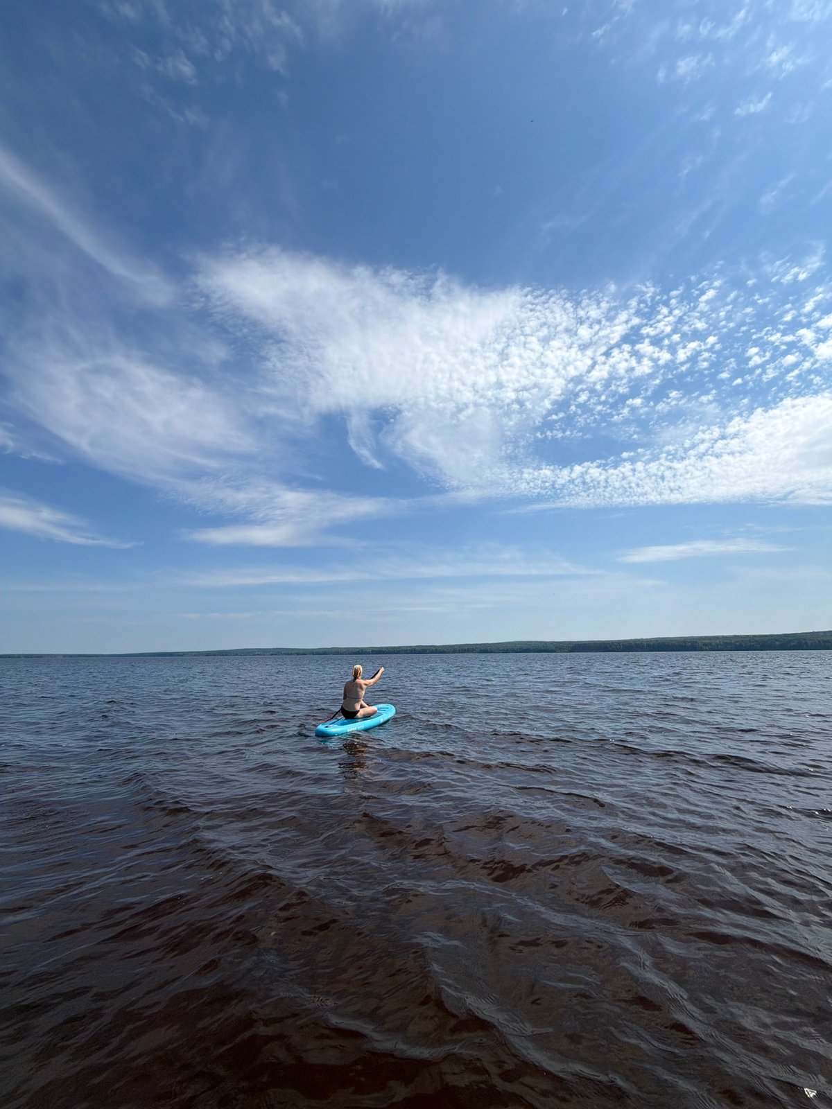 Paddleboarding on a dark lake near Chaikovsky, Russia