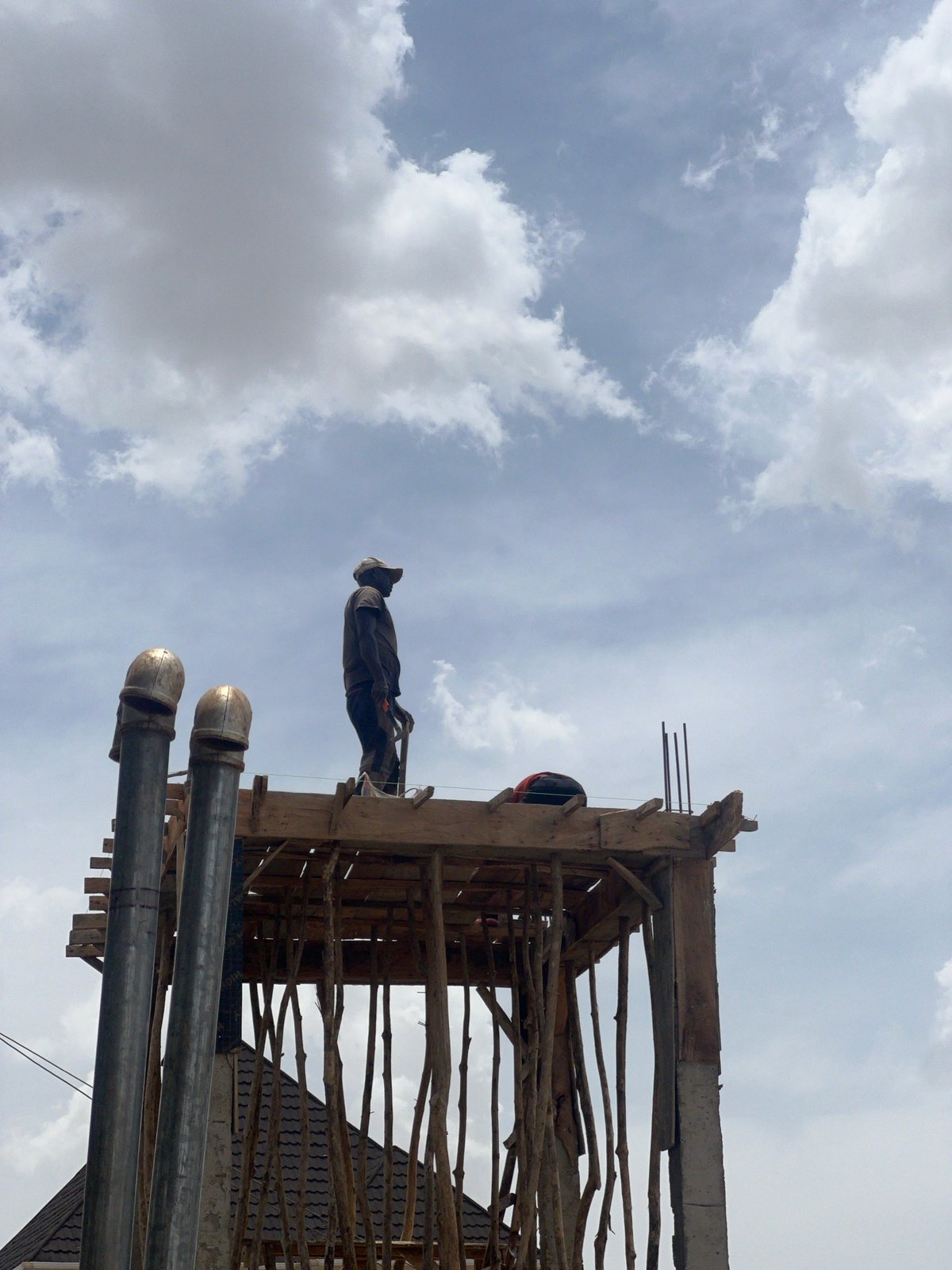 Construction workers build wooden structures in Jos, Nigeria
