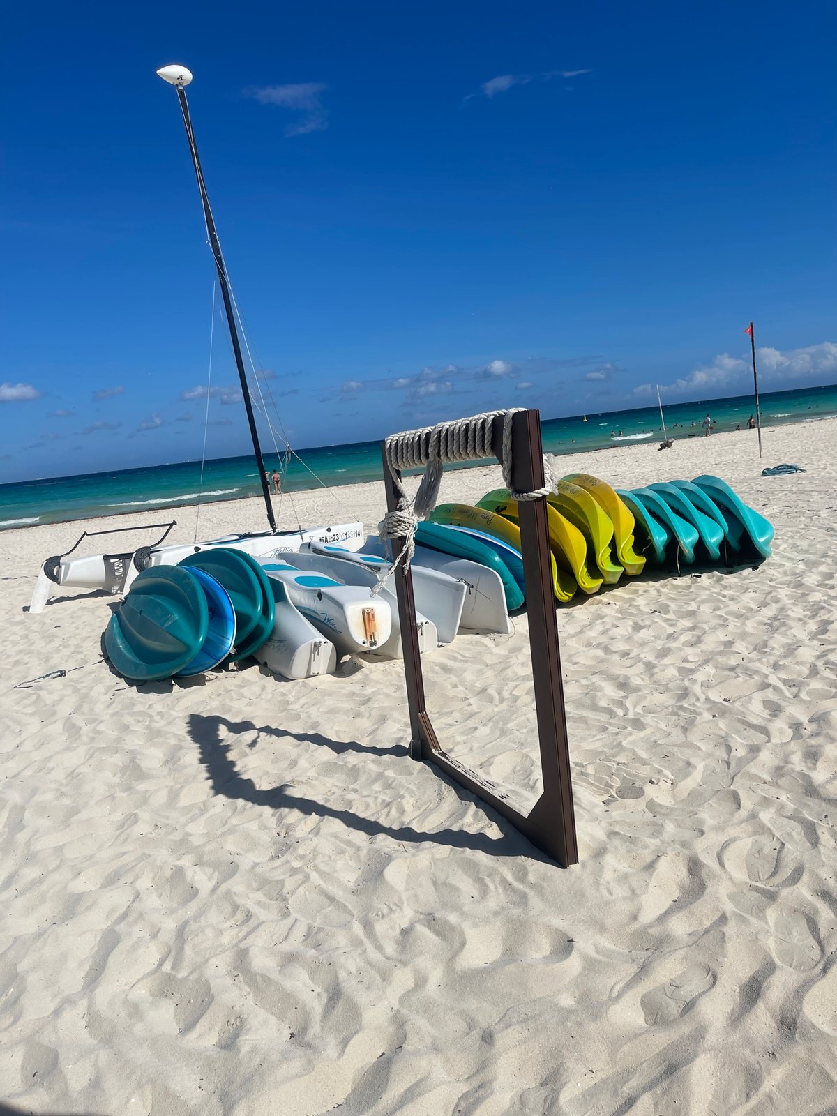Kayaks stacked on sunny Playa del Carmen beach