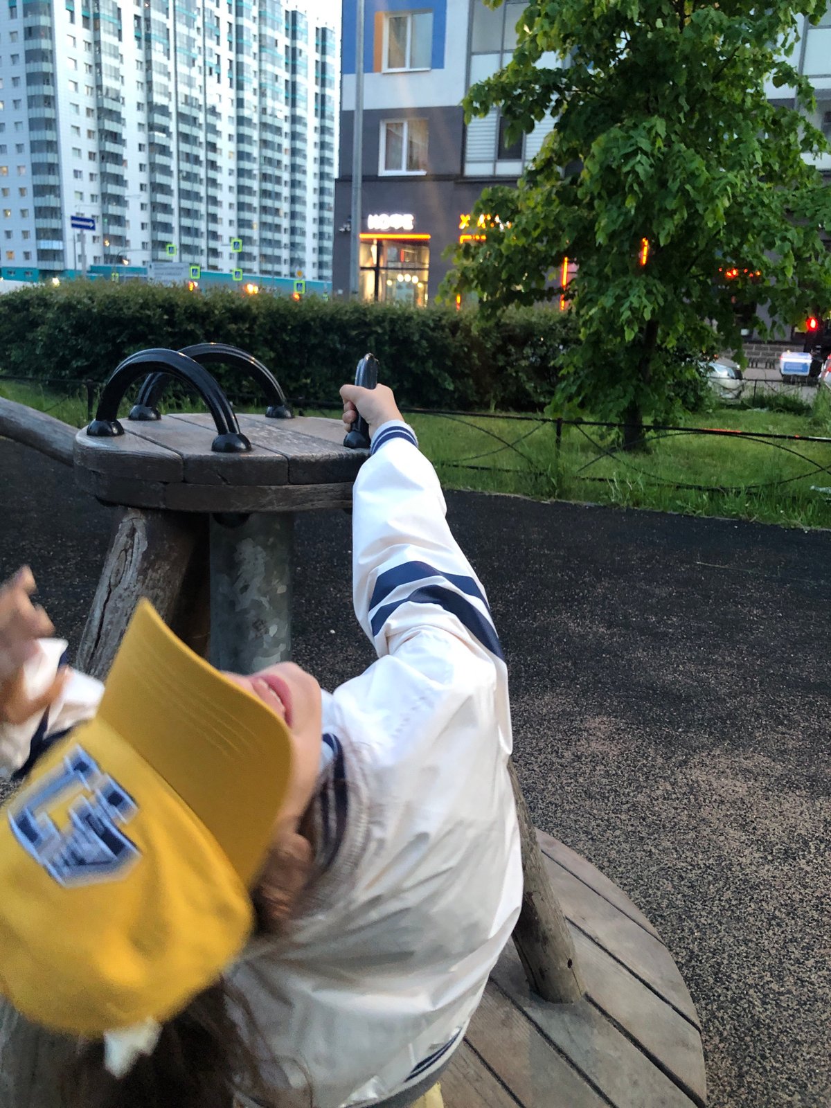 Child plays on Saint Petersburg playground during evening hours