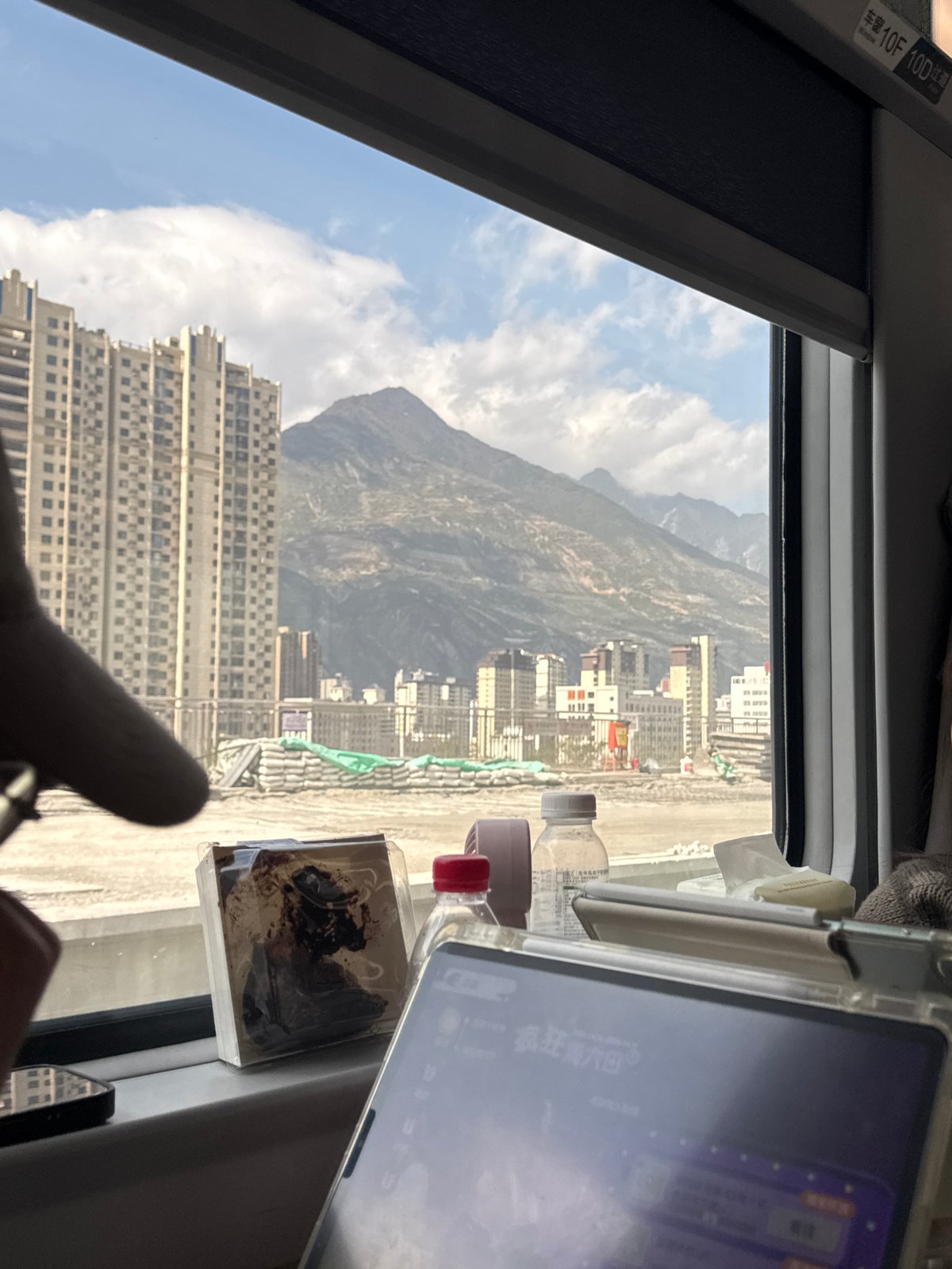 Train passenger captures window view while traveling through Longnan