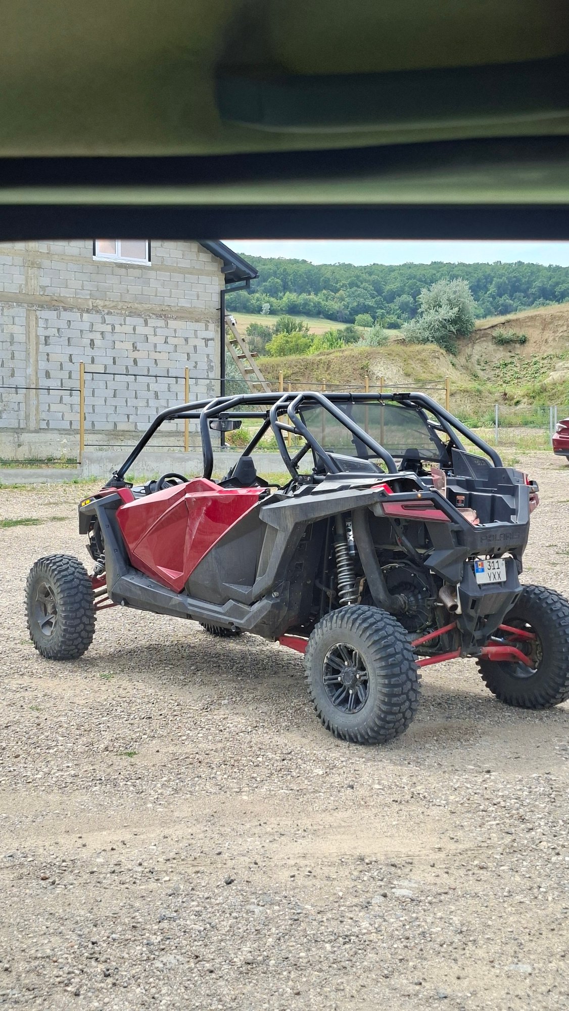 Polaris RZR parked on gravel near a construction site in Moldova
