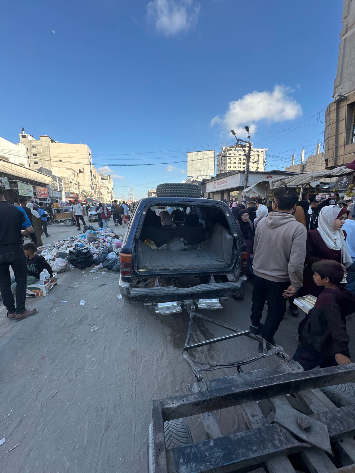 Gaza street markets bustling despite urban damage, families sheltering