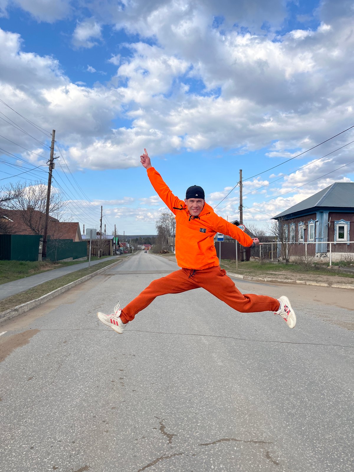 Young man performs dynamic poses during outdoor photoshoot in Chaikovsky