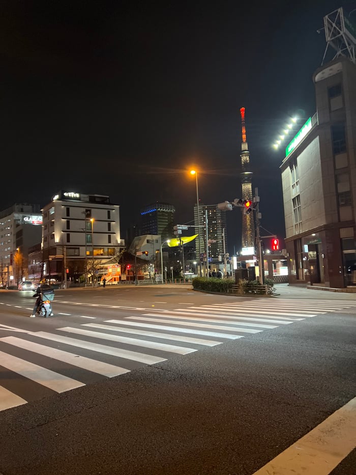 Tokyo Skytree illuminated red and white over Taito intersection