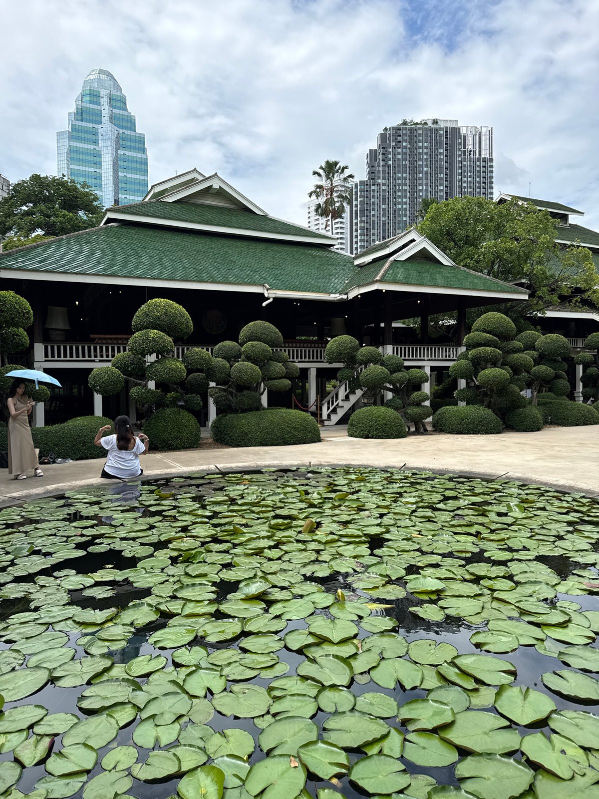Morning tranquility captured at Bangkok's Lumphini Park amid urban skyline