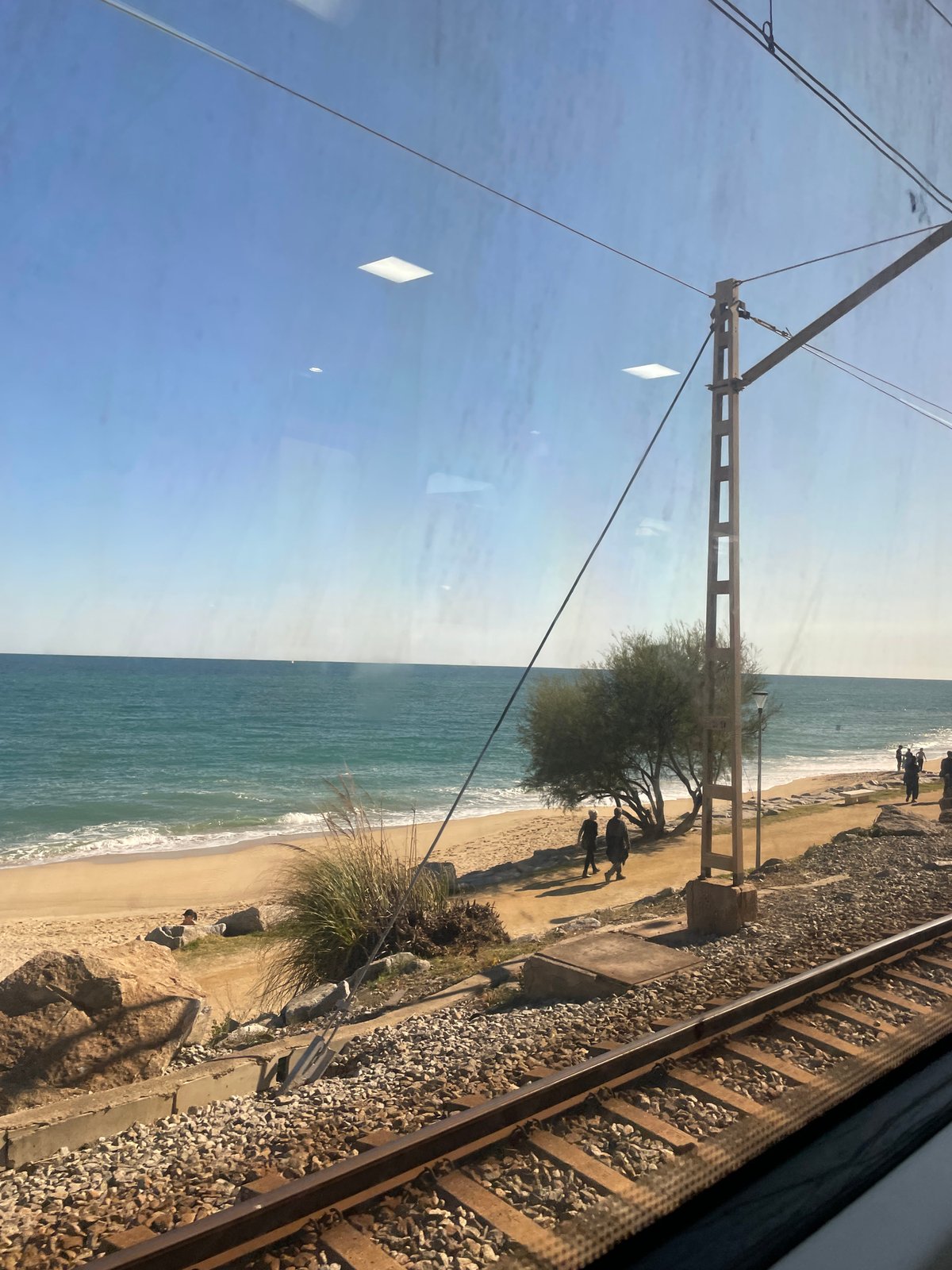Train passenger views Mediterranean coast near Sant Andreu de Llavaneres