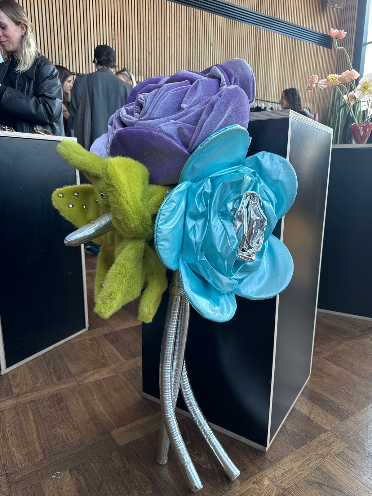 Person in Mickey Mouse helmet observed with fabric flowers