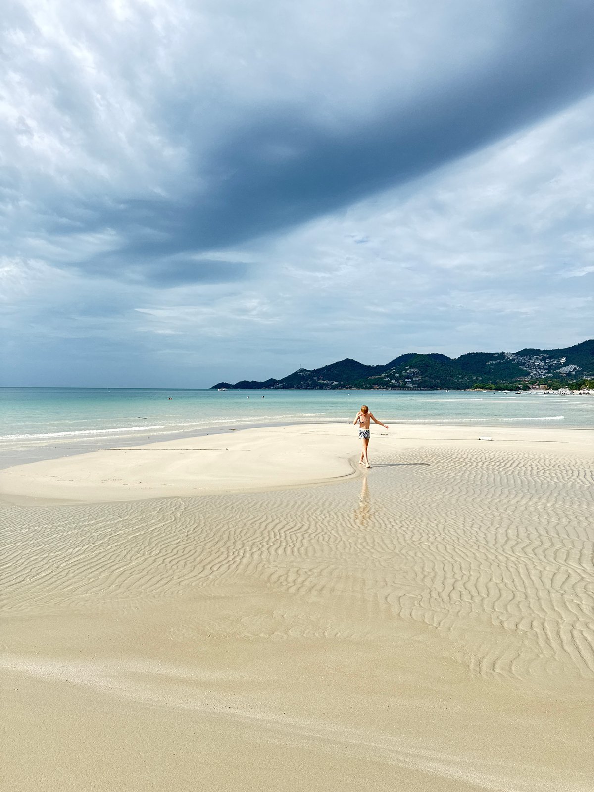 Cloudy morning on Ko Samui beach, inflatables in tow