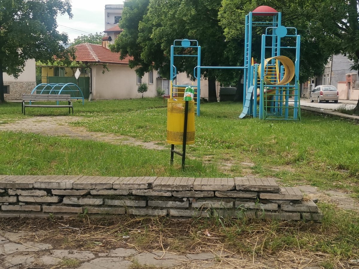 Empty park observed in Ihtiman, Bulgaria under overcast skies