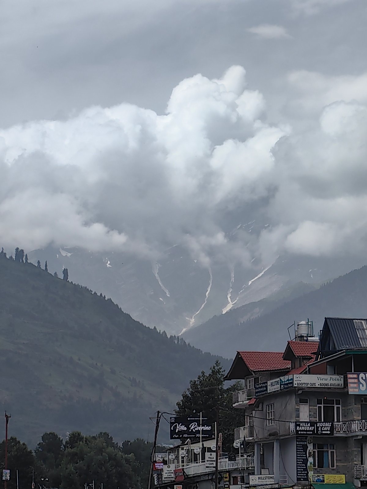 Overcast morning across Vashisht's mountains, river, and rooftops