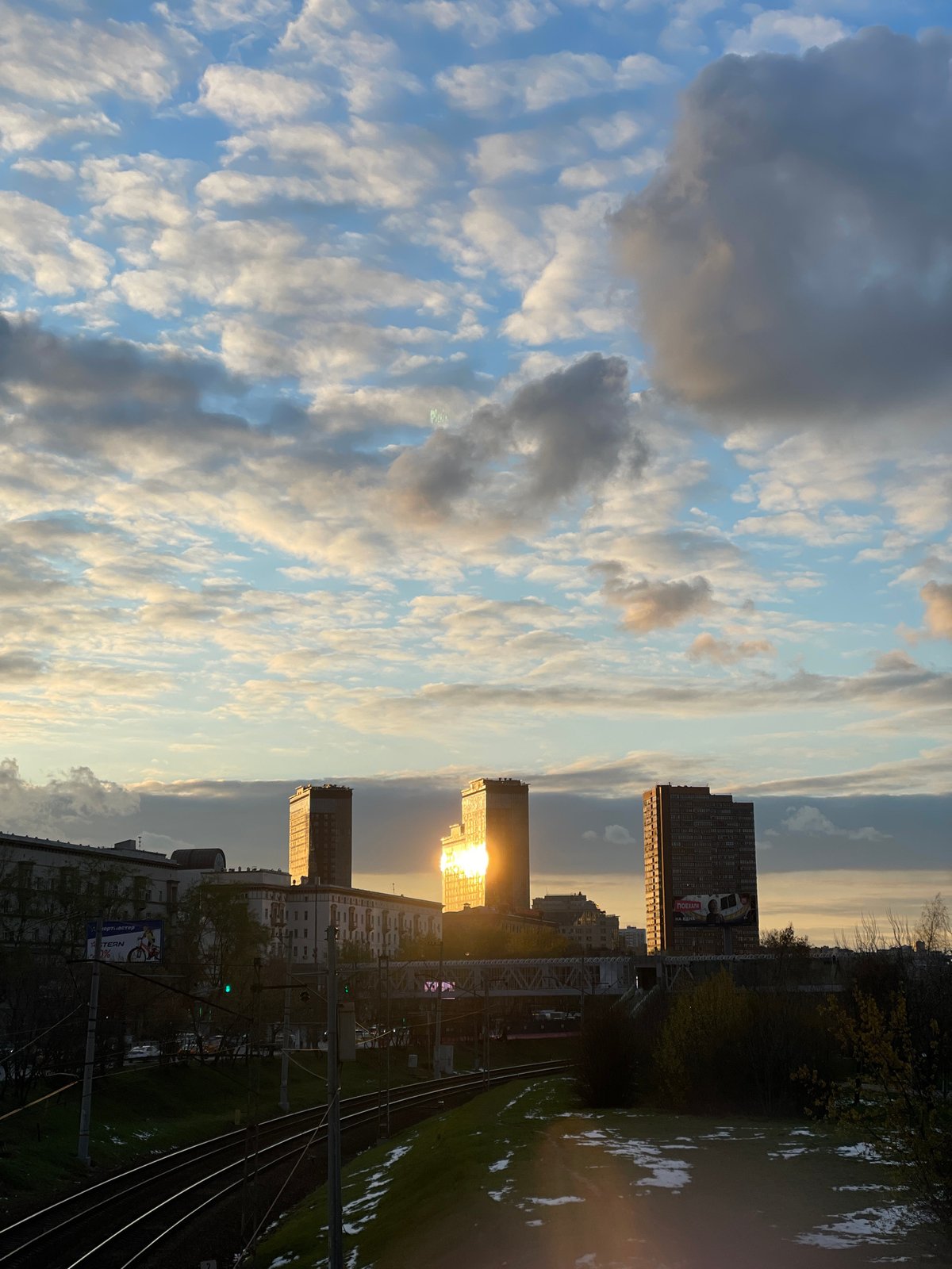 Golden hour sunset illuminates railway tracks in Khimki