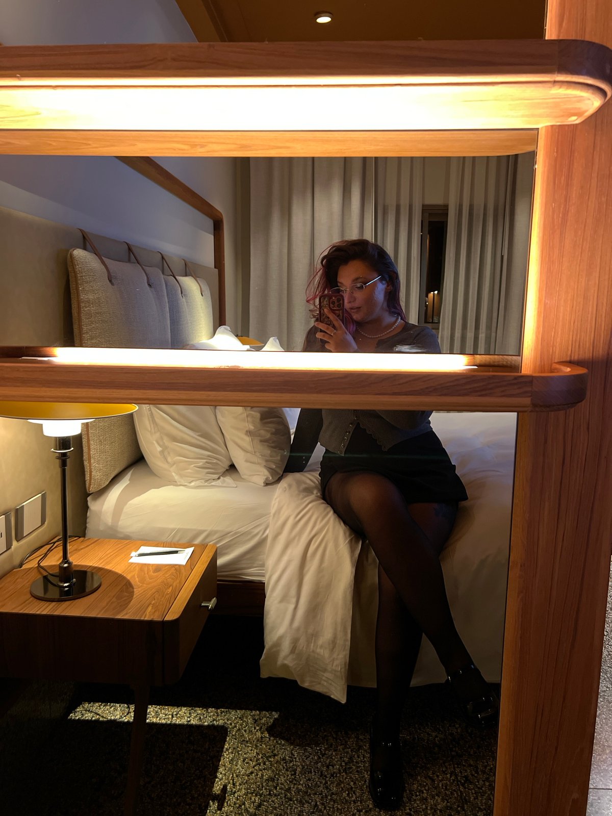 Young woman documents evening with selfies in Tel Aviv accommodation