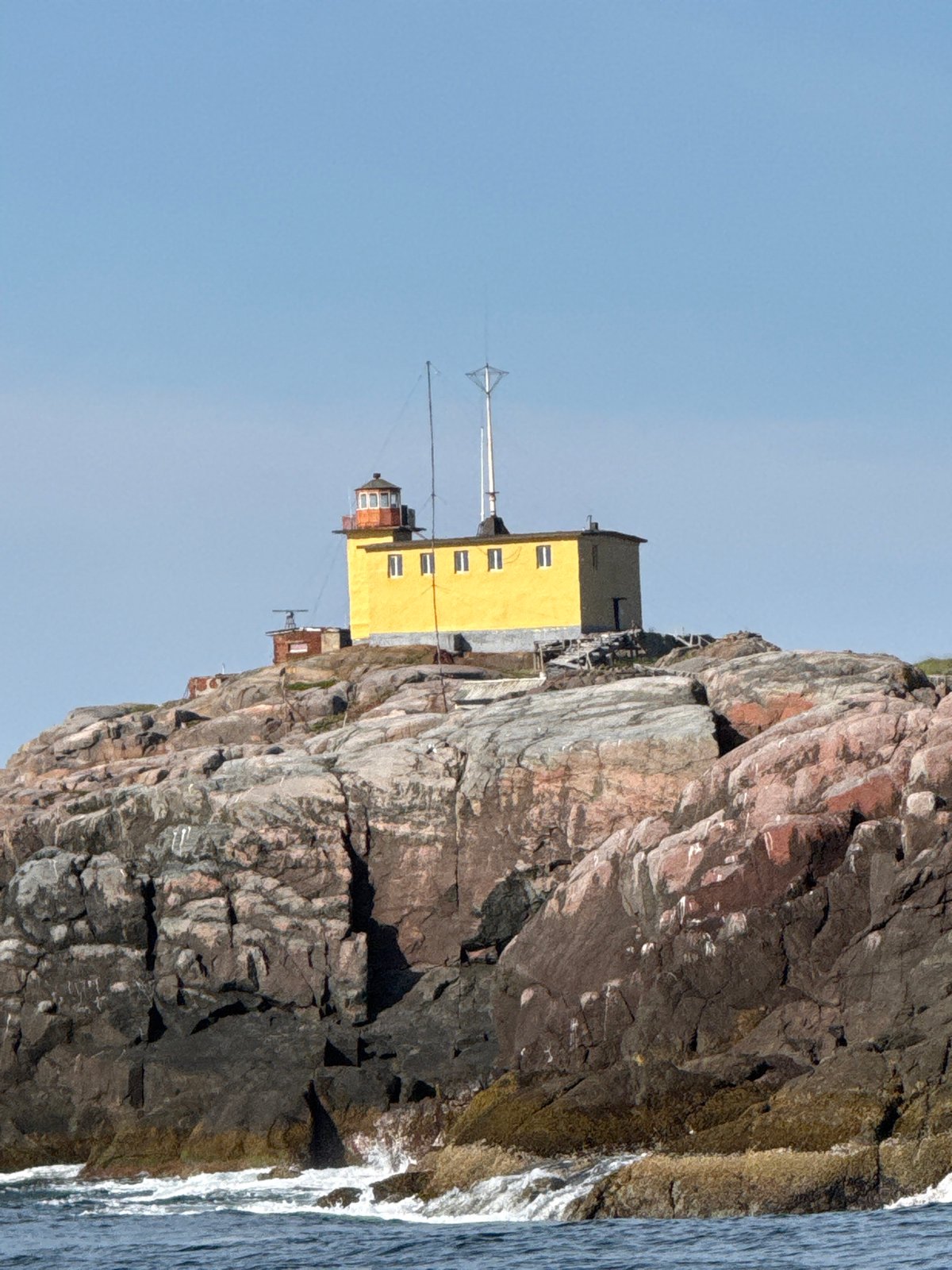 Yellow lighthouse on rocky Barents Sea coast, Teriberka