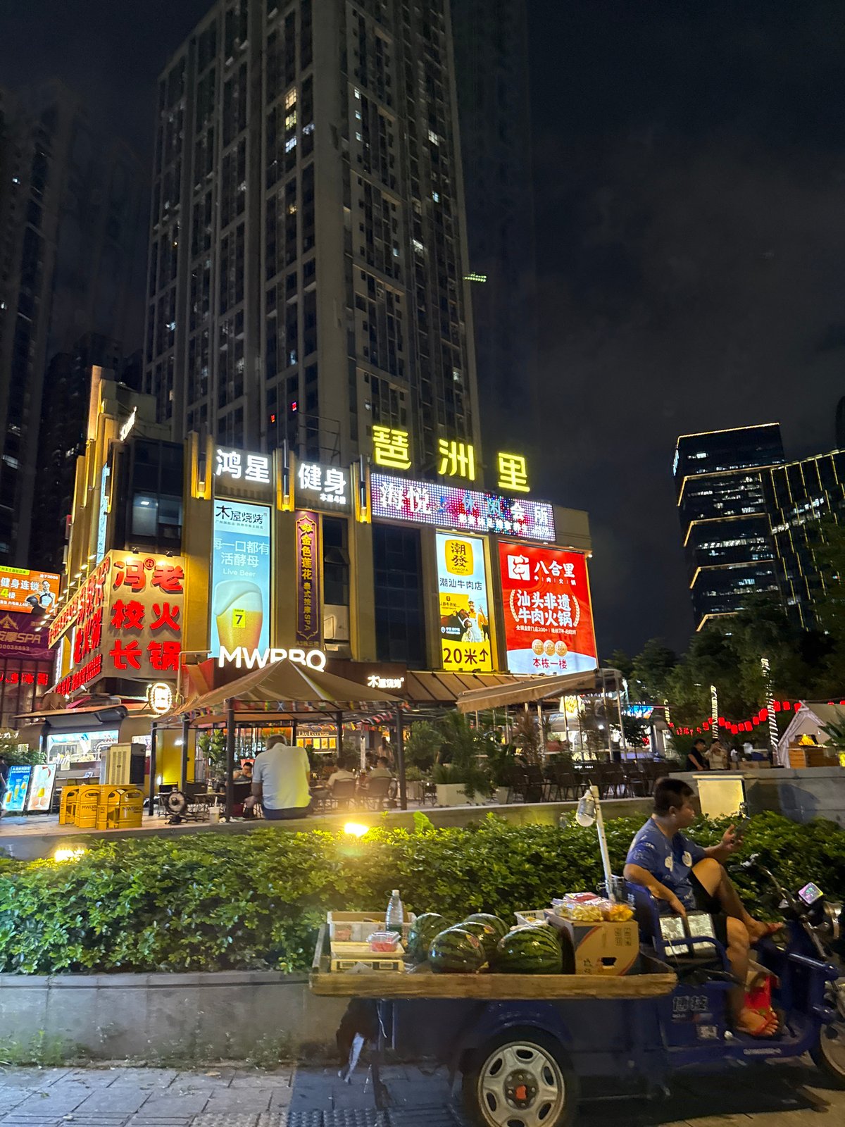 Haizhu District streets alive at midnight, neon and traffic