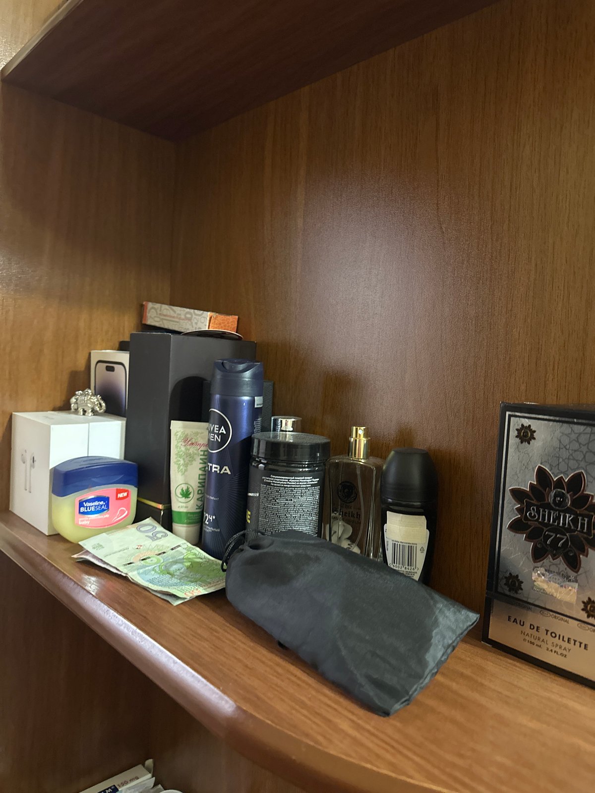 Personal items documented on shelves and wooden surface