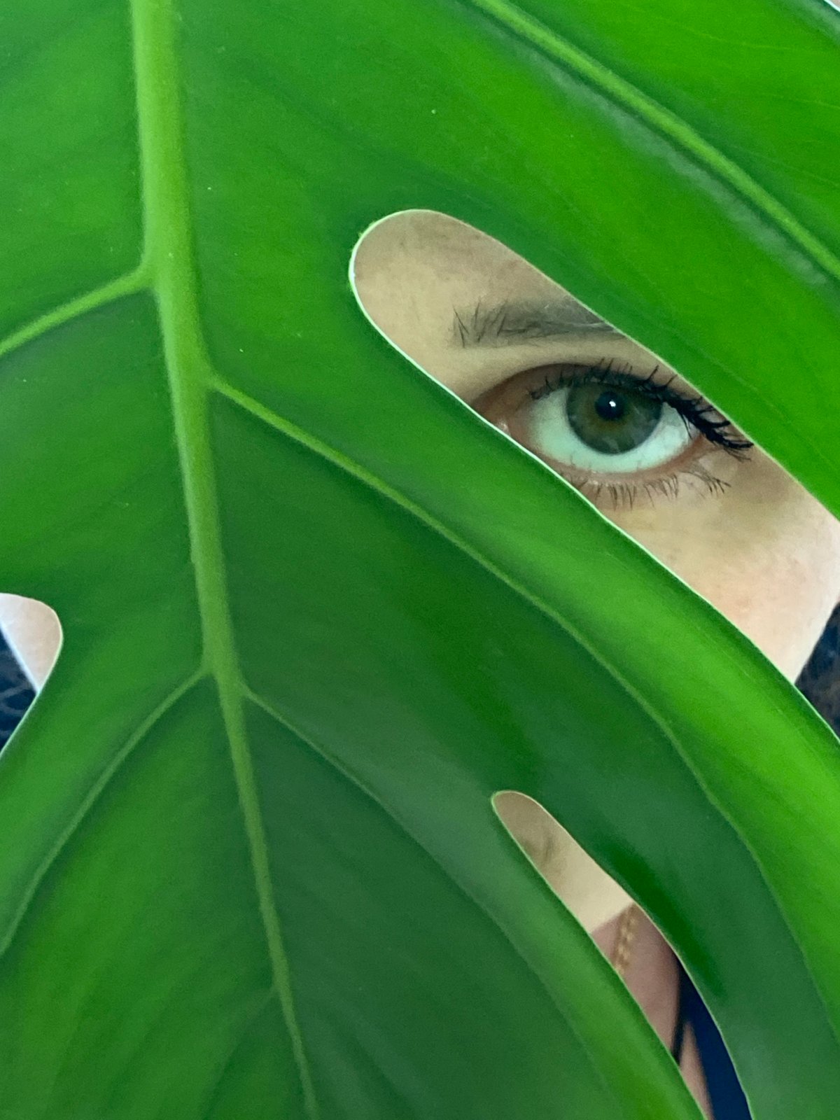 Person photographed with houseplants in Russian building
