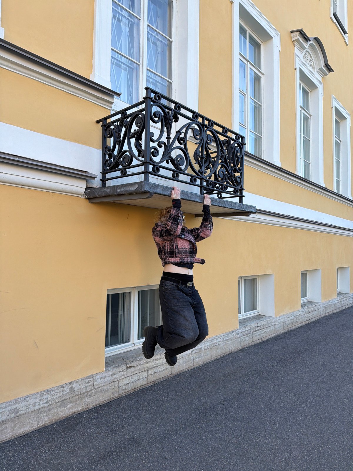 Tourists photograph historic Peterhof palace complex under clear skies