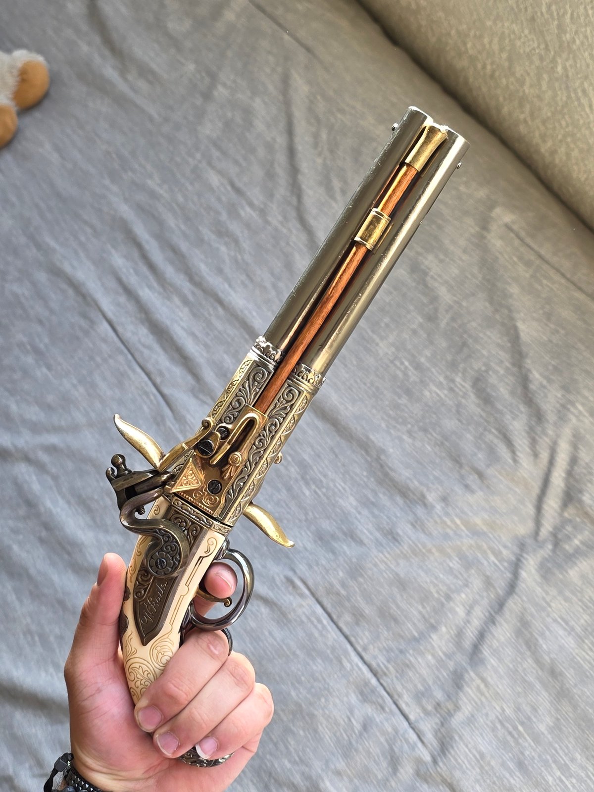 Person displays ornate antique pistol in Puebla, Mexico