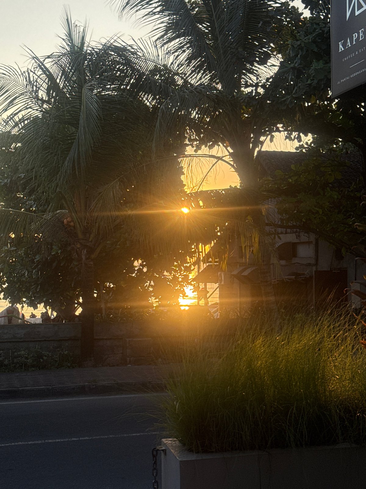 Tourist documents meal and sunset at Kuta restaurant