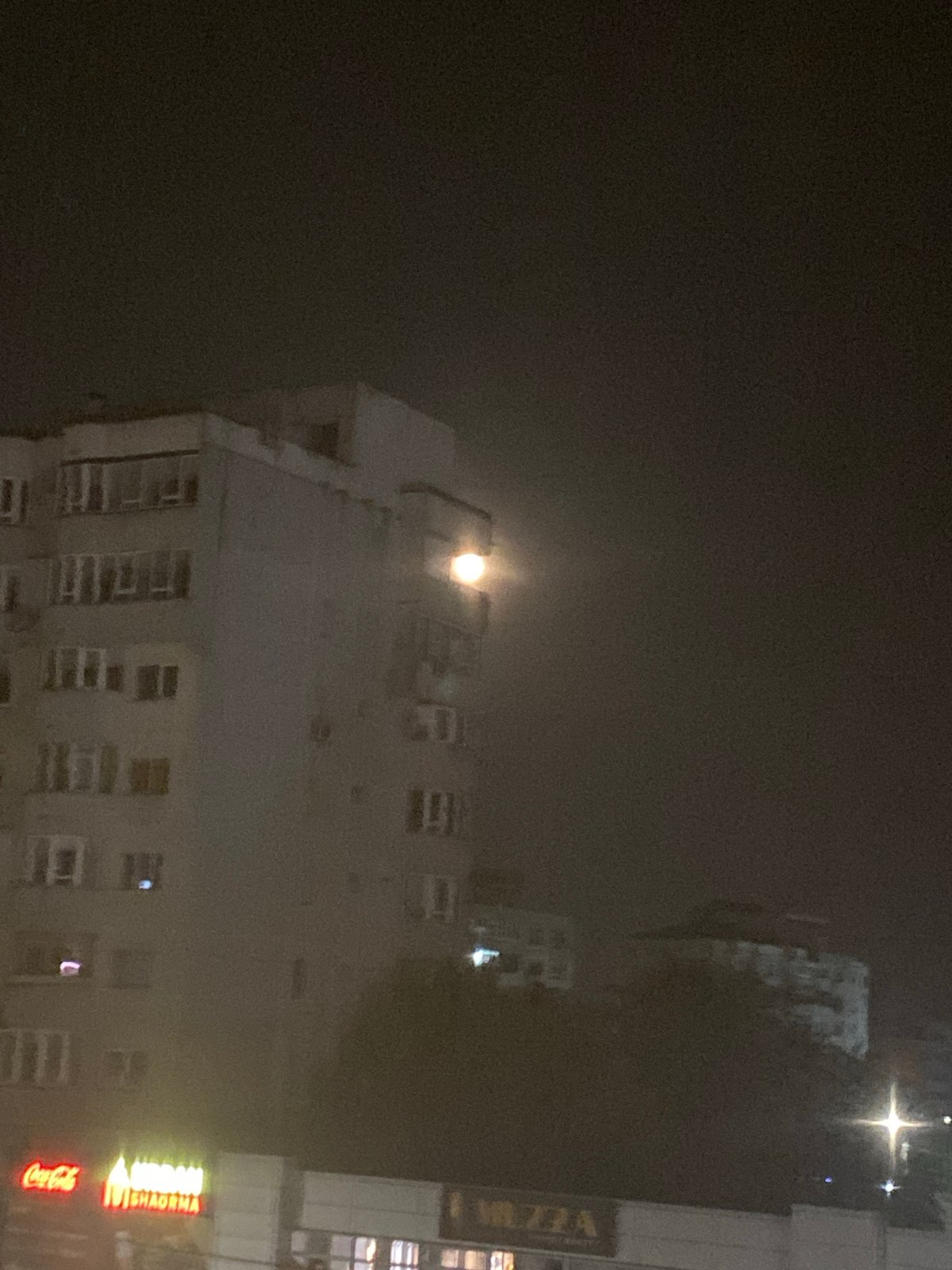Full moon rises over Iași's Nicolina neighborhood at night