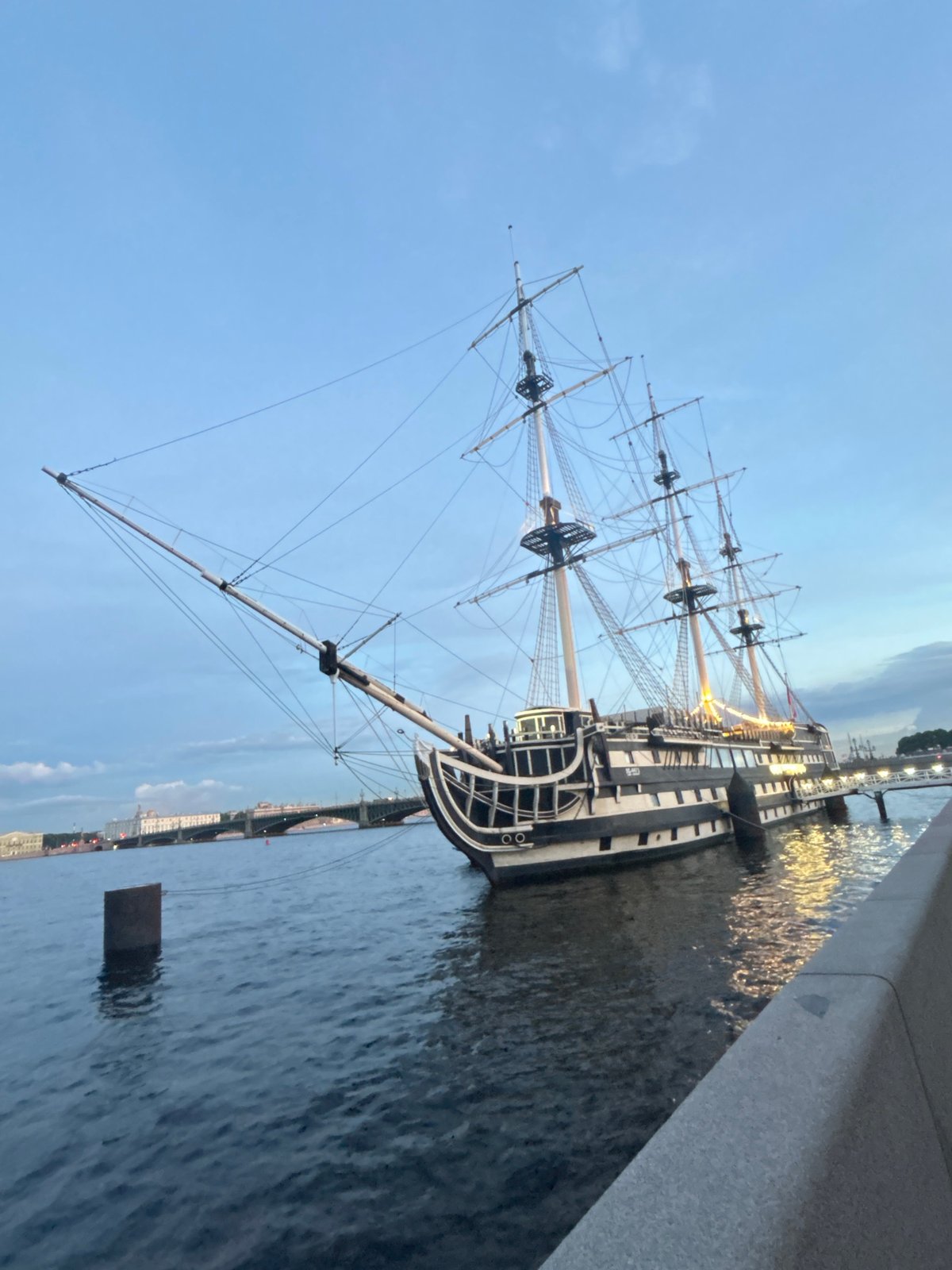 St. Petersburg waterfront at dusk: ships, bridges, and river light