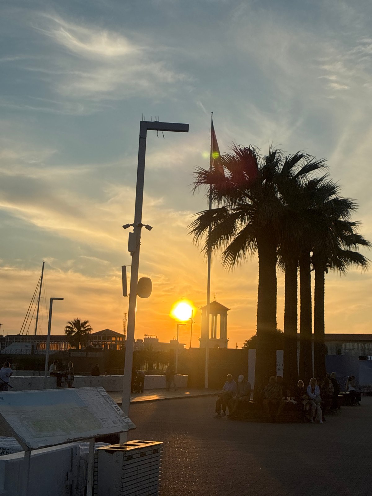 Evening life unfolds along Sochi's waterfront during golden hour