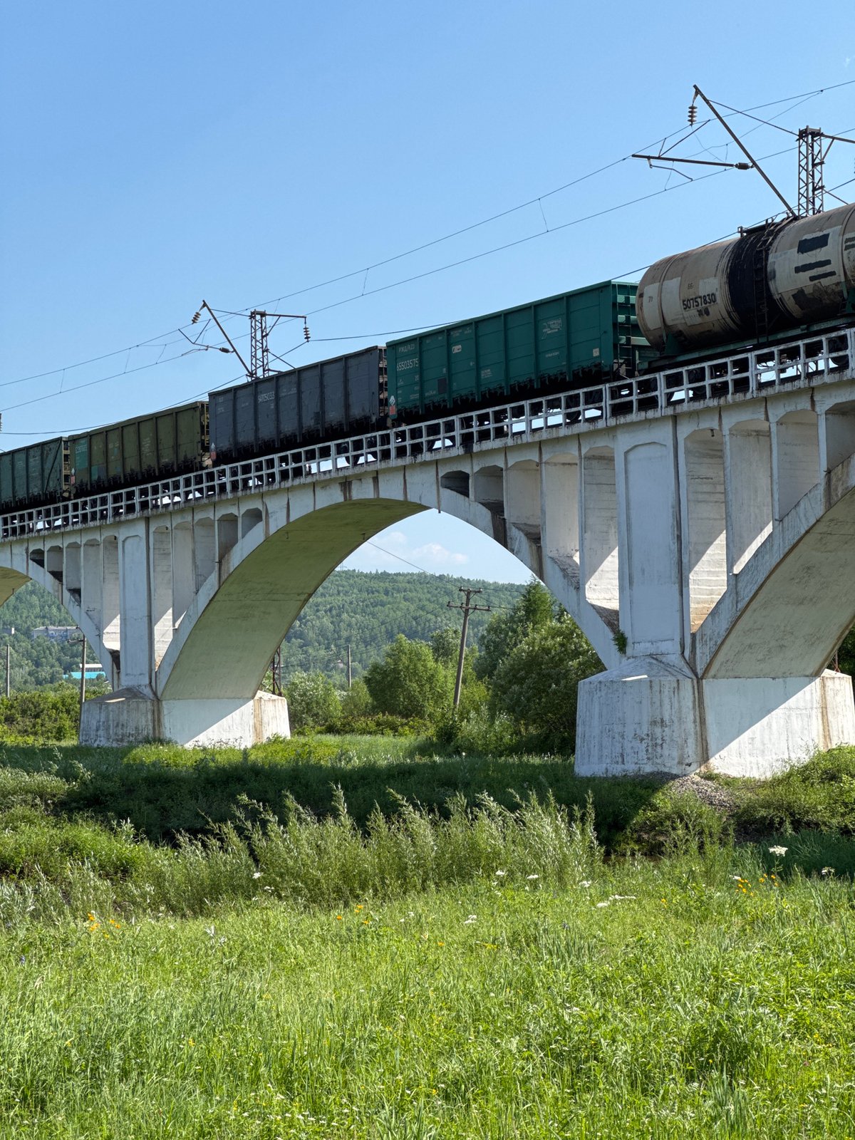 Freight train crosses viaduct in Skovorodino, Russia