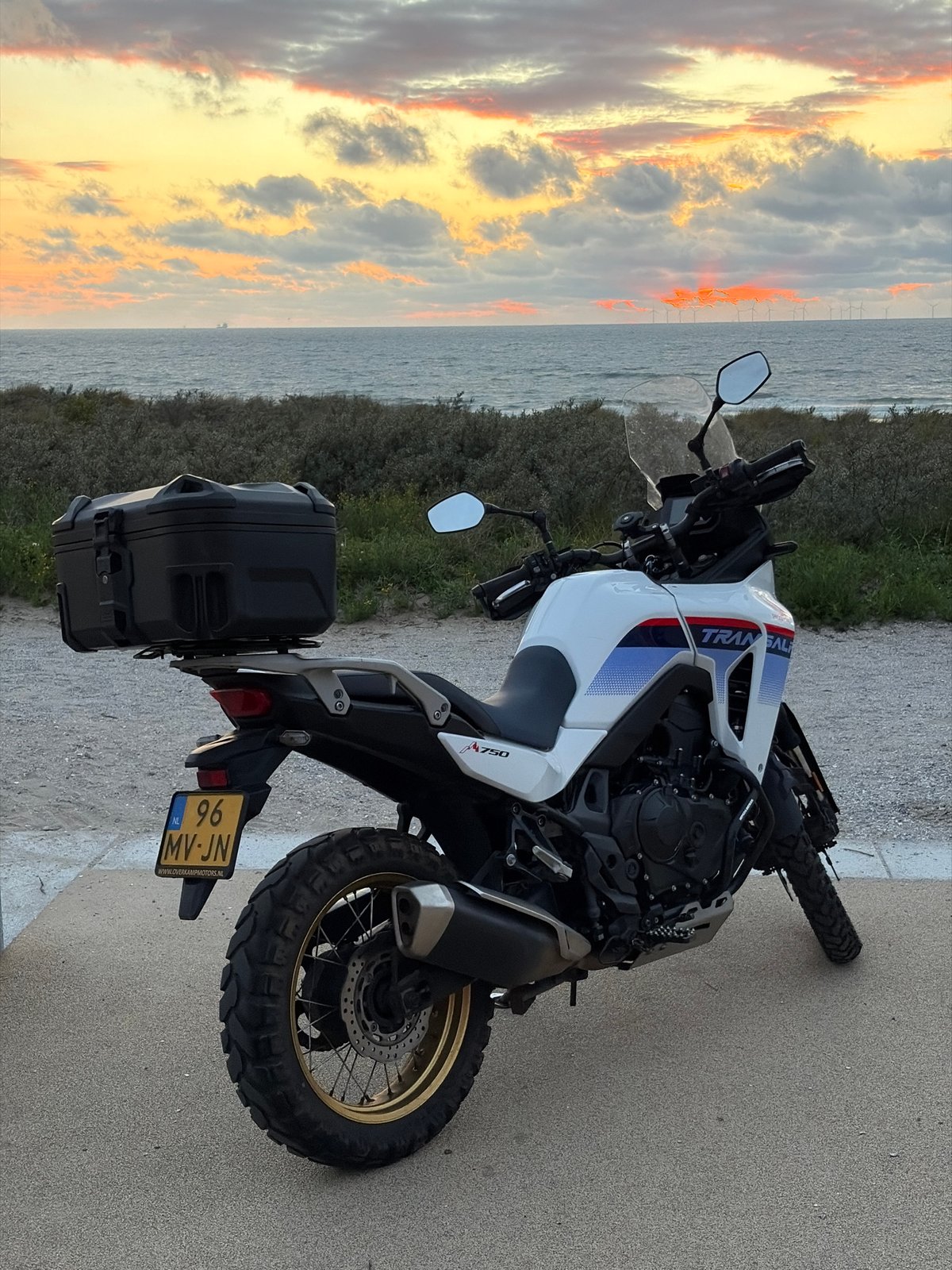 Honda Transalp parked at North Sea sunset near The Hague