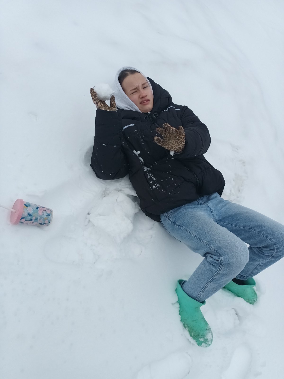 Person enjoys winter activities, drinks in snowy Russian village