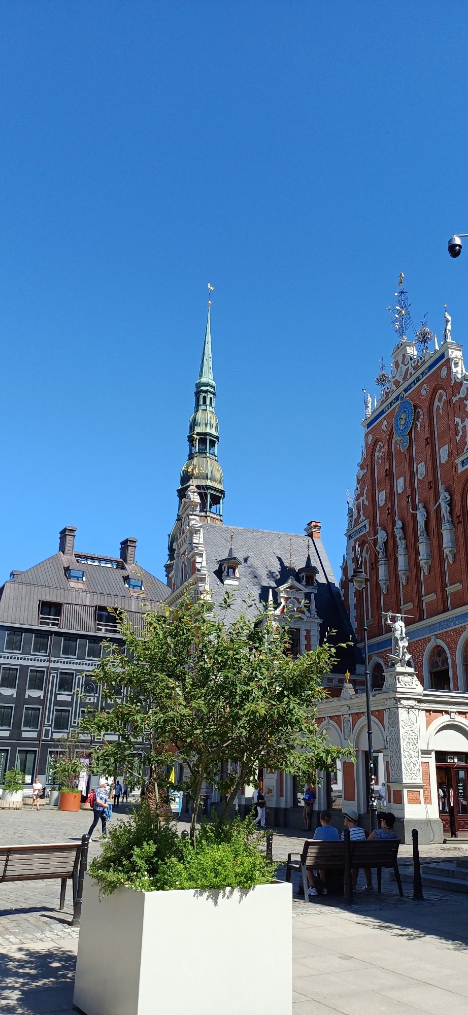 Sunny afternoon in a European city square with street sculpture