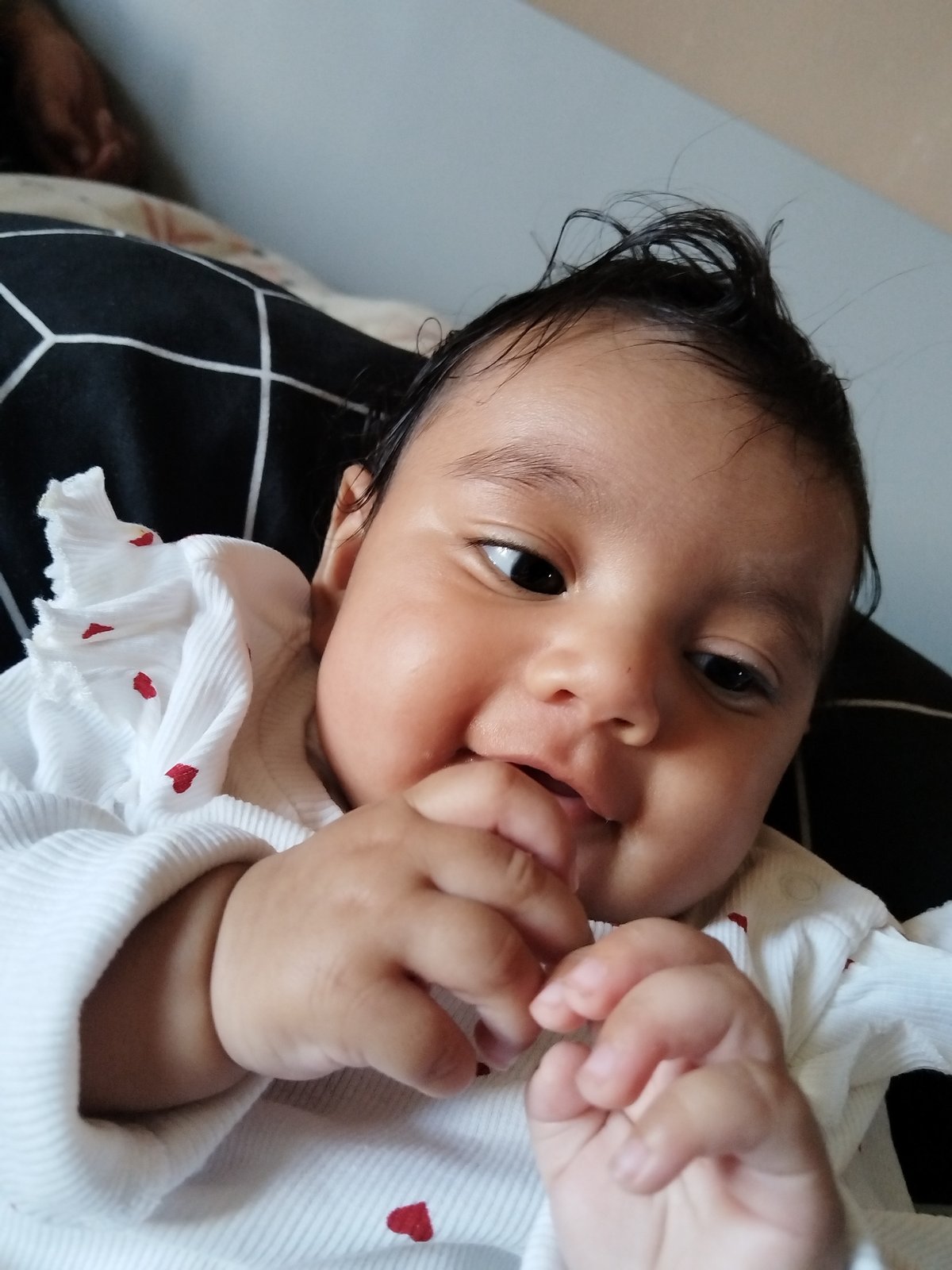 Baby and sleeping person captured in quiet indoor moments