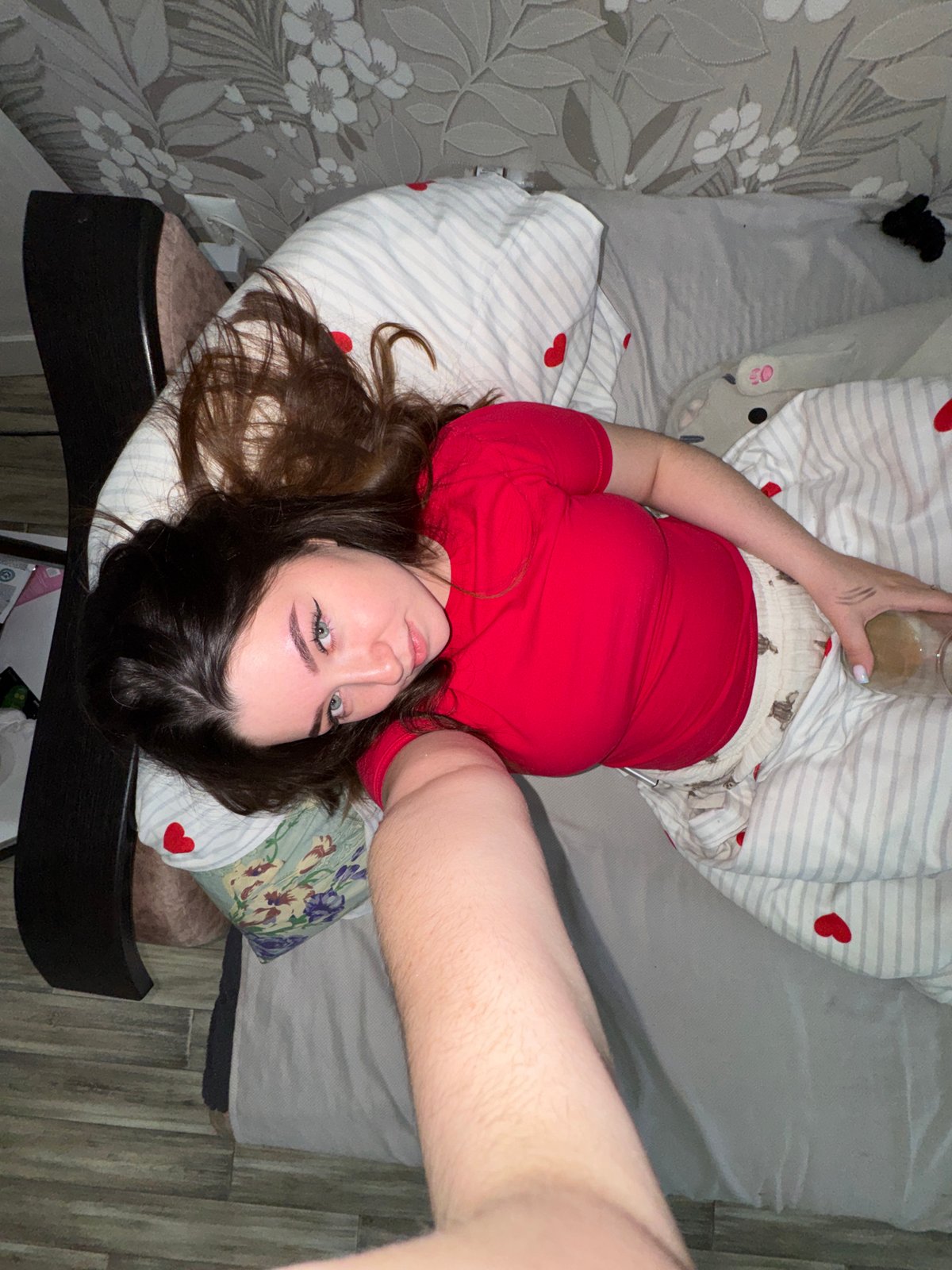 Woman Takes Selfie While Lying Down in Гамово