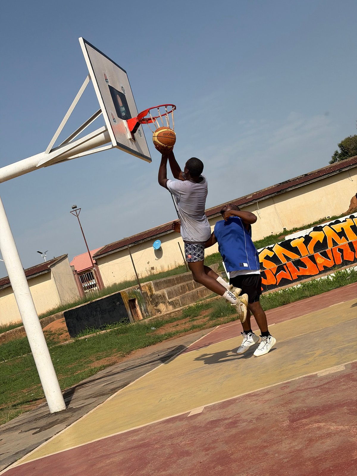 Morning basketball game captured on outdoor court in Jos