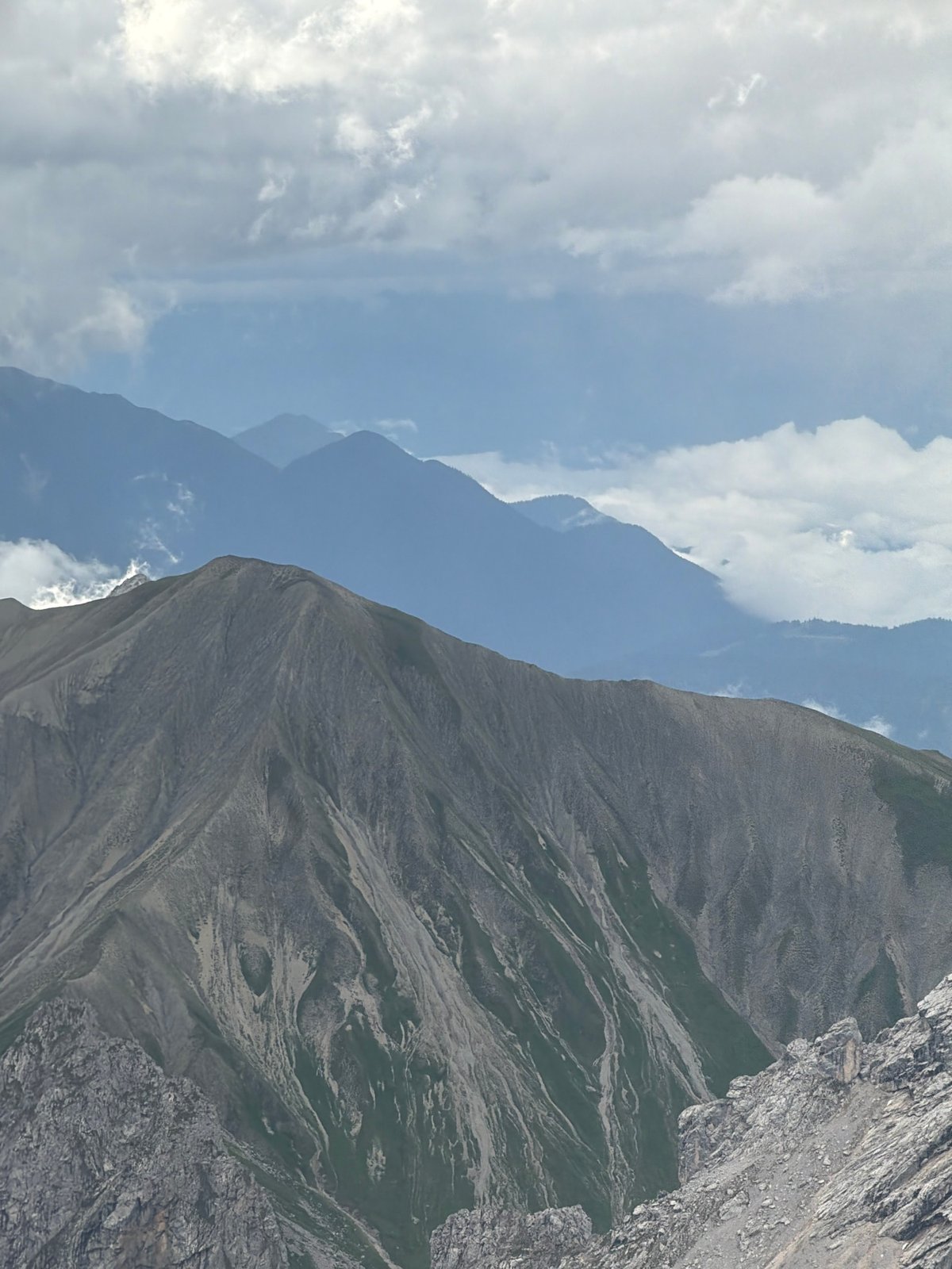 Layered Alpine ridgelines rise under cloudy skies near Garmisch-Partenkirchen