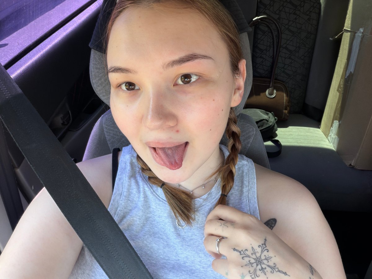 Woman takes car selfies during morning drive in Chaikovsky