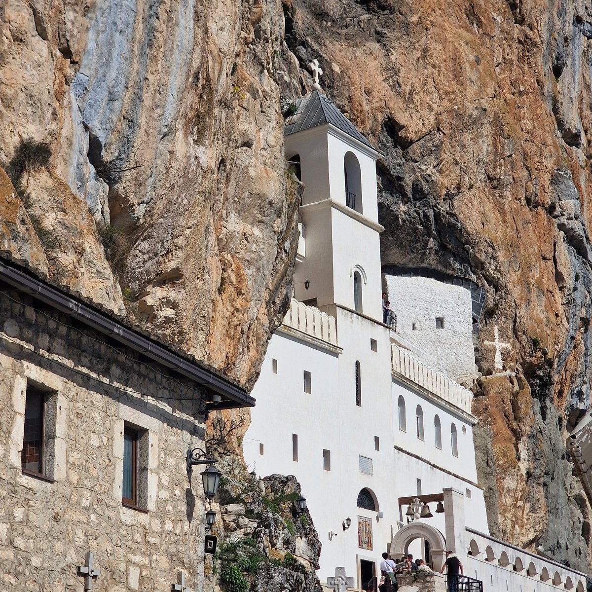 Pilgrims queue at cliff-built Ostrog Monastery in Montenegro