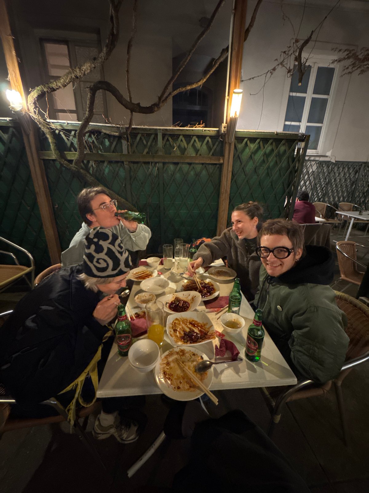 Three people share outdoor dinner in Vienna