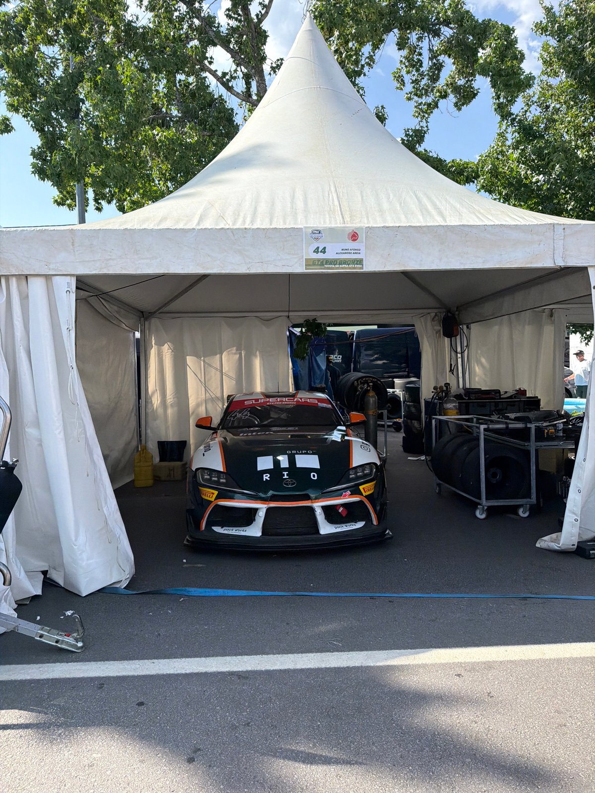 GT4 paddock at Vila Real: Supra and Gulf McLaren side by side